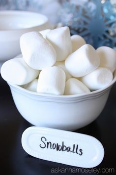 a bowl filled with marshmallows on top of a table