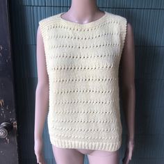 "Amazing vintage 70's pale yellow crochet tank top. Square shape, high neckline. Open at the armpit to the bottom edge. Size medium. Acrylic feel. No tags, handmade. Excellent vintage condition! So perfect. Will best fit small/medium. Measurements laying flat: fabric stretches. Pit to pit/waist: 16-18\" length: 22.5\"" Vintage Knitted Beige Tops, Vintage Beige Knitted Tops, Vintage Yellow Sleeveless Top, Cream Hand Knitted Top, Hand Knitted Cream Knit Tops, Vintage Crochet Sleeveless Top, Vintage Sleeveless Crochet Top, Vintage Sleeveless Crochet Top For Spring, Vintage Crochet Sleeveless Vest