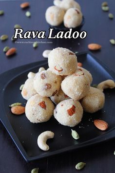 some food on a black plate with nuts and seeds scattered around it that says ravia ladoo