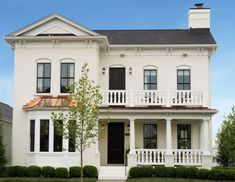 a white two story house with black shutters