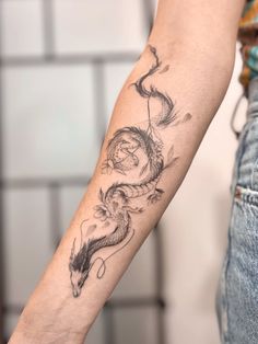 a person with a dragon tattoo on their arm