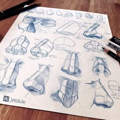 a bunch of drawings that are on top of a piece of paper with some pencils