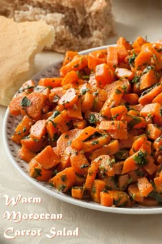 a white plate topped with carrots and bread