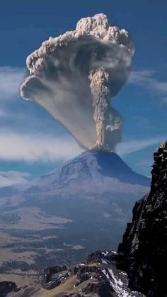 an active volcano spewing ash into the sky