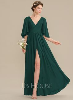 a woman in a long green dress with a slit down the side and her hand on her hip