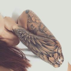 a woman with tattoos laying on her stomach