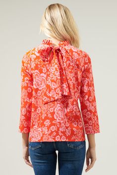 Even on the most casual days, you'll be boasting with main character energy when you're wearing the Tiana Floral Astana Mock Neck Blouse! A bright, floral print decorates this blouse that features long sleeves, a mock neck and a super cute bow tie back. You'll create a dynamite duo when you style this top with your favorite jeans! - Mock neck- Long sleeves- Back bow tie - Relaxed fit- Color: Red PinkSize + Fit - Model is 5'8" and wearing size XS- Measurements taken from size S - Chest: 19 1/2"- Spring Stretch Top With All Over Print, Stretch Top With All Over Print For Spring, Stretch Tops With All Over Print For Spring, Fitted Top With All Over Print For Spring, Fitted Tops With All Over Print For Spring, Pink Long Sleeve Top With All Over Print, Spring Cotton Tops With All Over Print, Cotton Stretch Floral Print Blouse, Floral Print Stretch Tops For Work