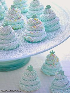 frosted cupcakes on a plate with sprinkles