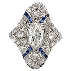 Antique Edwardian Art Deco Filigree Marquise Diamond and Caliber Sapphire Ring set in Platinum. Circa 1910 Marquise 8.85 x 5.00 x 3.01 = 0.88 cts estimated H in Color VVS 2 in Clarity 30 Old Mine Cuts = 0.66cts estimated H in Color VS-SI in Clarity 11 Calibre Cut Blue Sapphires ( 1 missing ) 4.1 grams in weight Finger Size 5 3/4 22 x 16.5 mm shank is 1.70 mm Art Deco Filigree, Edwardian Art, Edwardian Jewelry, Marquise Diamond, Short Hair Cuts, Ring Set, Ring Sets, Blue Sapphire, Sapphire Ring