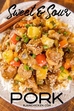 a white plate topped with meat and veggies next to chopsticks on top of rice