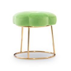 a green stool with gold legs and a round cushion on the bottom, in front of a white background