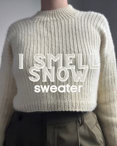 a woman wearing a white sweater with i smell snow written on it