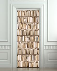 an open door with bookshelves on it in front of a white wall and floor