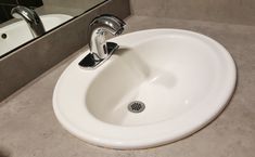 a white sink sitting on top of a bathroom counter