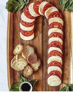 sliced tomatoes and bread on a wooden cutting board