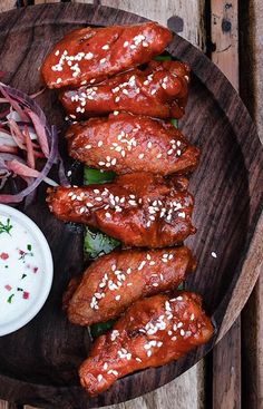 chicken wings on a wooden platter with cole slaw and ranch dressing