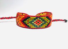 This beaded friendship bracelet is an original design, inspired from the styles of Native American and Huichol Indians of Mexico bead work. It's 9 lines wide, made traditional size11 seed beads. 100% handmade on a loom.  Measurements: just over 1/2" wide and closes at 6", but is expandable to fit larger wrist sizes. You can also contact me with your exact wrist size for a custom fit or if you're looking for custom colors. You may also be interested in these similar designs: https://www.etsy.com/ On Fire, Friendship Bracelet, Custom Fit, Friendship Bracelets, Original Design, Bead Work, Custom Color, Seed Beads, Native American