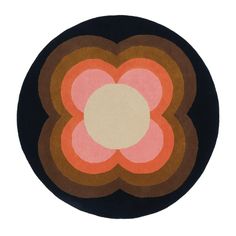 a circular rug with an orange and pink flower on the center is shown in front of a white background