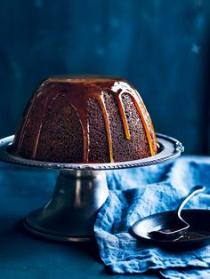 a bundt cake with chocolate icing and caramel drizzle