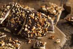 pieces of chocolate and nuts on a cutting board