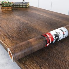 a roll of wood glue sitting on top of a wooden table