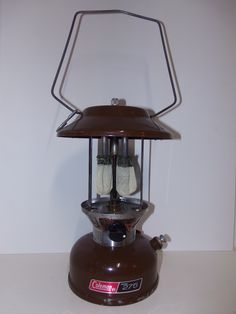 an old fashioned gas stove with two burners on the top and bottom, sitting on a white surface