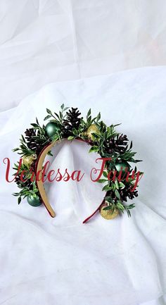 This Christmas headpiece is a holiday headband with a woodland / rustic feel to it.  The perfect blend of  woodland and glam with greenery, glitter, pine cones and baubles. This easy to wear piece fits children (over approx 5 yrs) and adults alike as it is mounted to a flexible,  toothed headband. Both sides are beautifully decorated, so you look fabulous from all angles and either side can be worn as the front feature. The artificial glittery pine cones are burgundy/ red wine in colour. Much mo Christmas Headpiece, Headband Christmas, Christmas Pine Cones, Holiday Headbands, Christmas Hair Accessories, Christmas Headband, Rustic Holiday, Christmas Hair, Costume Hats