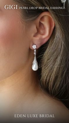 a woman wearing earrings with pearls on the ear and in front of her is an advertisement for