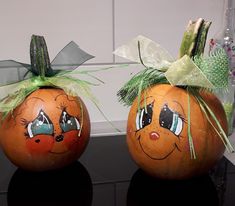 two pumpkins with faces painted on them