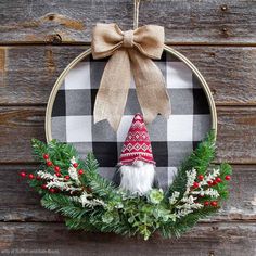 a wreath with a gnome's hat hanging on it