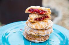 three donuts stacked on top of each other with powdered sugar and jelly toppings