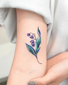 a woman with a flower tattoo on her arm