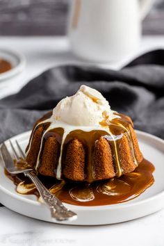 a white plate topped with cake covered in caramel sauce