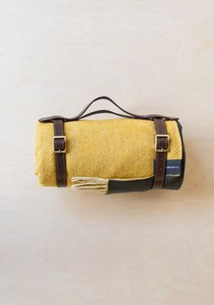 a yellow and brown blanket hanging on a wall