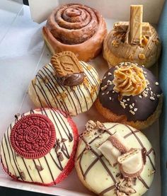 a box filled with different types of donuts