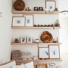 the shelves are filled with pictures and other things on top of each shelf in this living room