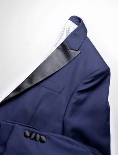 This is the navy version of our most classic tuxedo: our favorite navy super 110s wool we have been using for years accented with a matching black satin, making both colors pop. This tux will be your go-to for any formal occasion. FABRIC AND TRIMS: Super Super 110s wool plainweave woven in Italy by Vitale Barberis Canonico 9.17 Oz Weight SEASONALITY: Suitable for year-round use in most climates COLOR: Navy BUTTONS: Covered in accent fabric ACCENT FABRIC: Black satin on lapel, hip pockets, and bu Classic Tuxedo For Winter Black-tie Events, Classic Tuxedo For Black-tie Events In Winter, Classic Winter Tuxedo For Black-tie Events, Blue Tuxedo Style Evening Outerwear, Luxury Winter Tuxedo With Pressed Crease, Elegant Tailored Navy Tuxedo, Classic Winter Tuxedo, Elegant Navy Tuxedo For Semi-formal Occasions, Navy Fitted Tuxedo For Formal Events