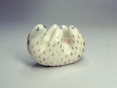 a white ceramic bird sitting on top of a table