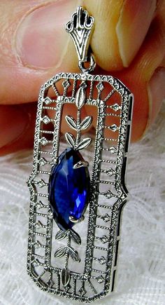 Simulated Blue Sapphire Pendant  Marquis Leaf Design#P21 Custom Made This amazing pendant has been re-fashioned from an Art Deco pin (dated from the 1930's). This pendant is handcrafted in solid sterling silver.  The stunning 1.5 carat simulated blue sapphire gemstone is 12mm x 6mm.  The pendant is just shy of 1 3/4" x 11/16".  The sterling silver chain (if chosen) is adjustable between 18-20" long.   The marking of 925 on the jewelry assures you of quality value sterling silver. The lovely marq Blue Sapphire Pendant, Filigree Necklaces, Cheque Design, Sapphire Pendant, Antique Design, Engraved Items, Sapphire Gemstone, Leaf Design, Sterling Silver Chains