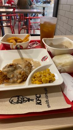 a table topped with plates of food next to bowls of fries and coleslaw