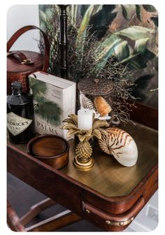 a wooden table topped with books and candles