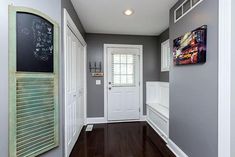 the hallway is clean and ready to be used as a mudroom or laundry room