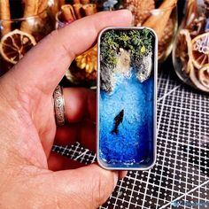 a person holding up a phone case with an image of a bird in the water