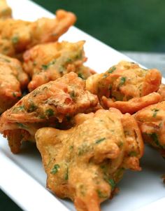 there are some fried food on a white plate