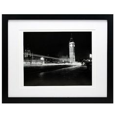 a black and white photo of big ben in london at night with the lights on