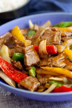 a blue bowl filled with meat and vegetables