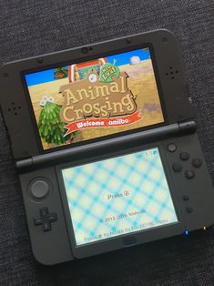 animal crossing new leaf on the nintendo 3ds. the 3ds is black 3ds Wallpaper, Animal Crossing Gamecube, Playing Animal Crossing, Vintage Console, Leaf Animals, Retro Games Console, Games Console