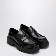 Black brushed leather loafer by Prada, features a round toe, a rubber sole with gussets and a metal and enamel logo triangle band. Size Type: UKMaterial: LeatherSKU: 2DG152G000B4L/P_PRADA-F0002_604 Our Products Are 100% Genuine. In All Cases We Stand By The Authenticity Of Every Product Sold On Our Site. Designer Business Loafers With Lug Sole, Designer Platform Loafers With Leather Sole For Business, Luxury Leather Loafers With Lug Sole, Luxury Business Loafers With Lug Sole, Designer Calf Leather Platform Loafers For Business, Logo Triangle, 2024 Vision, Prada Shoes, Black 7