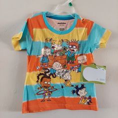 a t - shirt with cartoon characters on it and a tag attached to the front