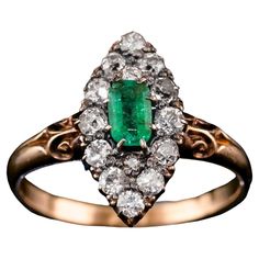 We are delighted to offer this superb Victorian 18ct gold ring with an intricate navette design made c.1880. Distinctly Victorian and distinguished from contemporary pieces, this gorgeous piece presents one central 'emerald-cut' emerald encompassed by 14 old mine-cut diamonds (approx 0.45ct total) that glisten wonderfully under lighting. The central emerald has a desirable rich green hue with slight hints of brighter greens depending on the angle of lighting. This is well contrasted by the diamo Velvet Interiors, Rich Green, Ruby Ring, Emerald Diamond, Cluster Ring, Antique Victorian, Bright Green, Emerald Cut, Special Gift